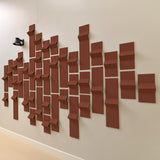 Dark orange acoustic felt tiles on a wall  in a modern geometric design