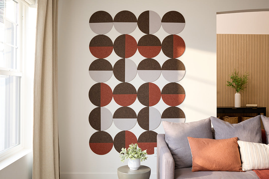 A Felt Right Design on a wall featuring a geometric pattern of circular tiles in shades of brown, gray, and white. Modern look for an entry way or living room space