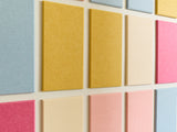 Colorful square tiles arranged in a grid on a light background