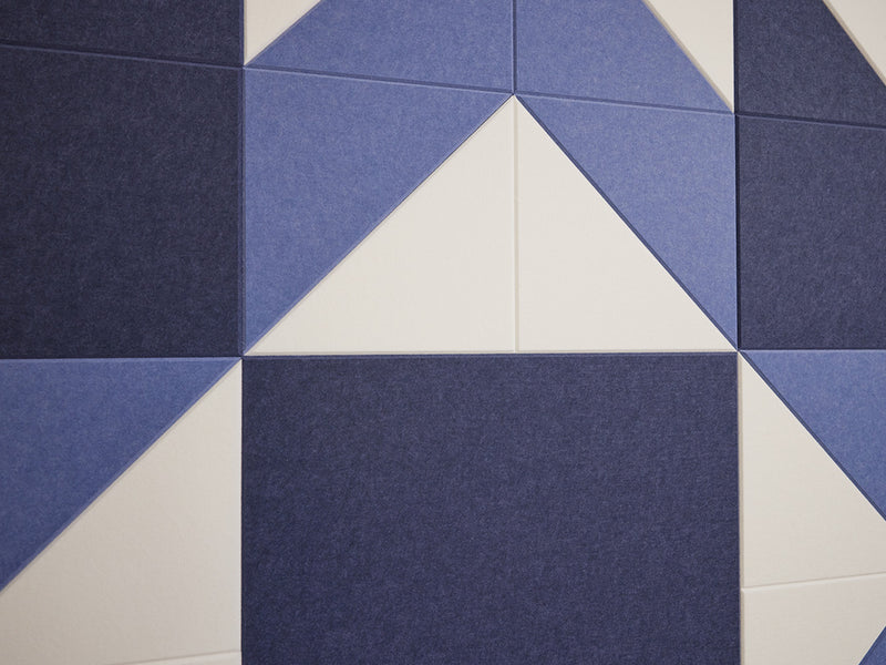 Acoustic wall tiles with a blue and white geometric pattern