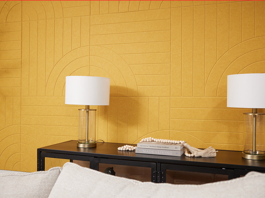 A Felt Right Wall design in a yellow shade in a living room behind a table with two lamps and a couch