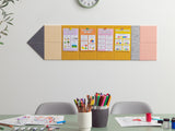 Colorful wall-mounted bulletin board with educational posters above a table with art supplies.