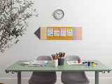 Desk with stationery items, a wall clock, and a colorful bulletin board in an office setting.