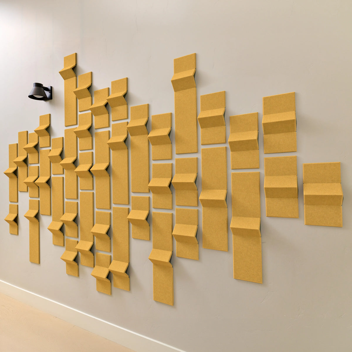 Dark yellow felt tiles with points of dimension that help with acoustics