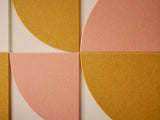 Geometric pattern with pink and mustard yellow shapes on a beige background