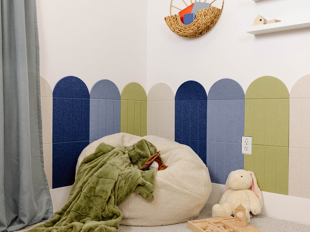Children's room with a bean bag, plush toys, and colorful wall design.