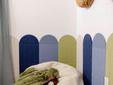 Children's room with a bean bag, plush toys, and colorful wall design.