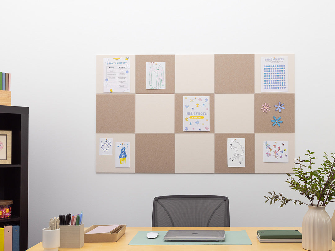Home office with a cork bulletin board, desk, chair, and decorative items.