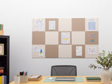 Home office with a cork bulletin board, desk, chair, and decorative items.