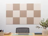 Checkered wall paneling above a desk with office supplies and decor.