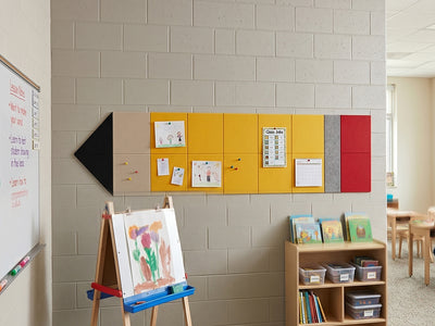 Educational setting with bulletin board, easel, and bookshelf in a classroom.