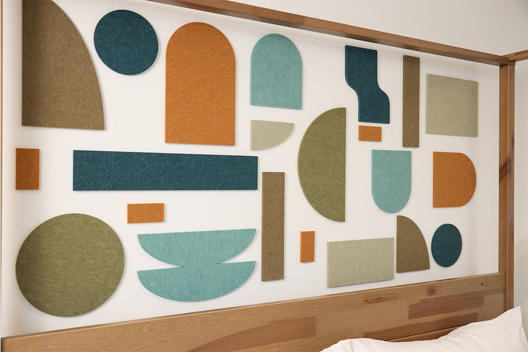 Organic decorative shapes installed on wall behind bed.