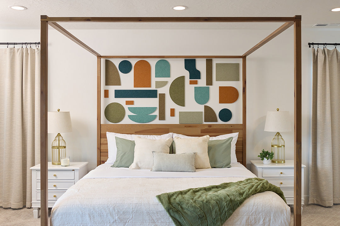 Organic decorative shapes installed on wall behind bed.