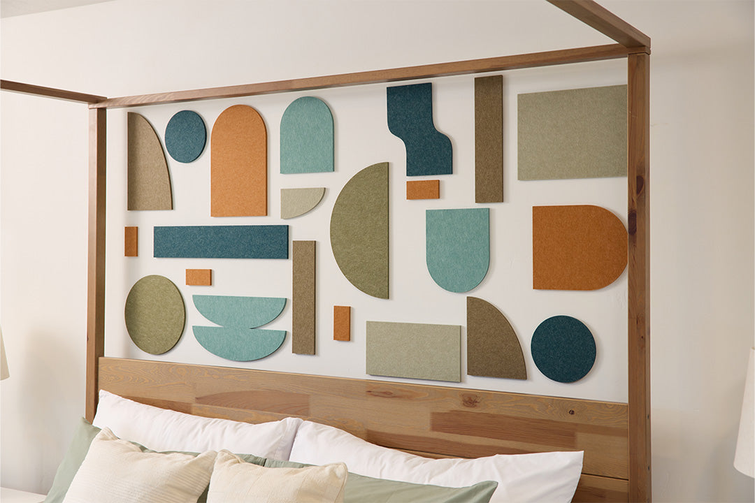 Organic decorative shapes installed on wall behind bed.
