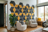 Black and yellow hexagonal acoustic wall panels arranged in geometric pattern above seating area.