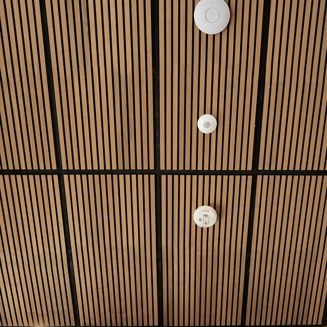 Close-up of wood ceiling panels
 with brown and black striped pattern