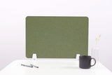 Sage green desk divider with white base supports and rounded corners on white desk.