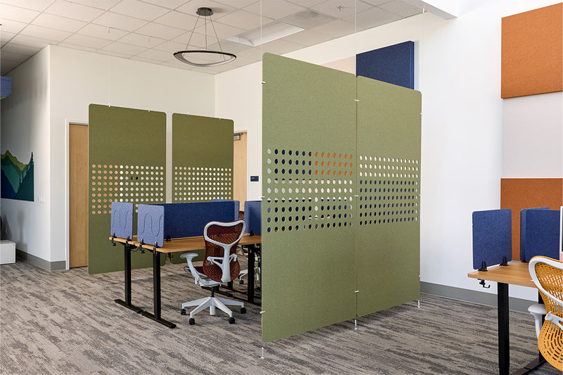 Modern office setup with green partition walls and office furniture.