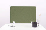 Sage green desk divider with chevron pattern and white metal base supports on white desktop.