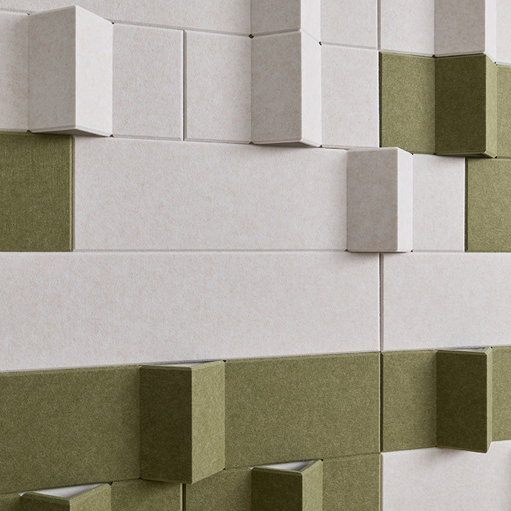 3D geometric wall panels with a textured finish in off-white and olive green, arranged in a staggered block pattern.