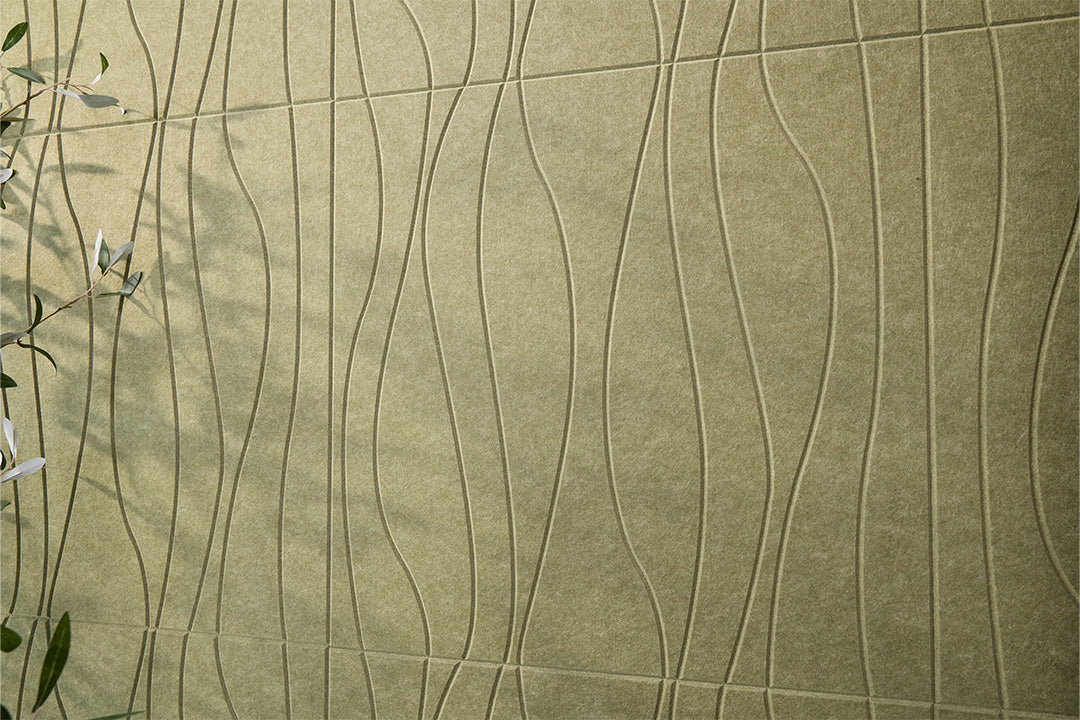 Textured green acoustic wall panels with wavy patterns and leaves on the side