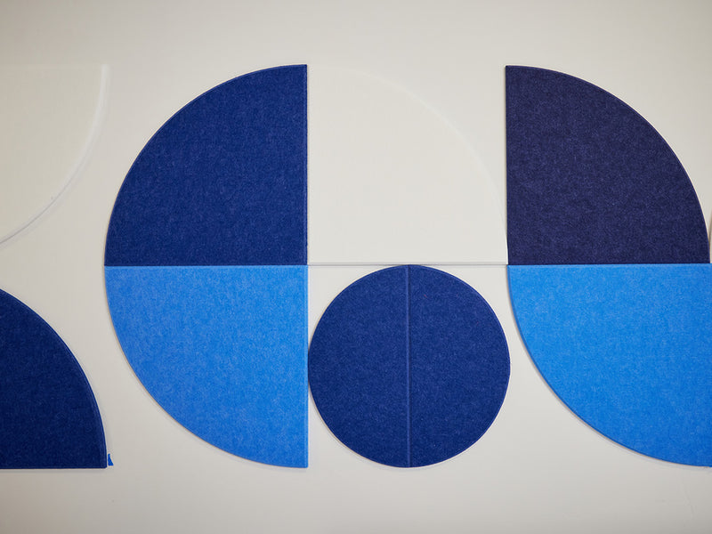Blue circular and half-circle shapes on a white background