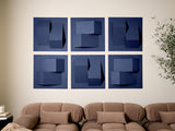 Six blue square panels with dimensional geometric shapes and cutouts arranged in a 2x3 grid on a wall above tan upholstered f