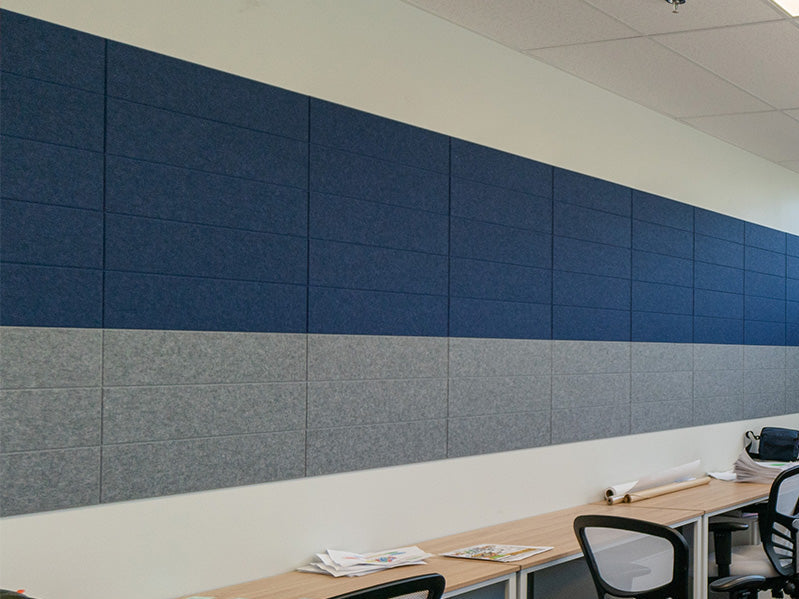 Modern office space with blue soundproof panels on the wall