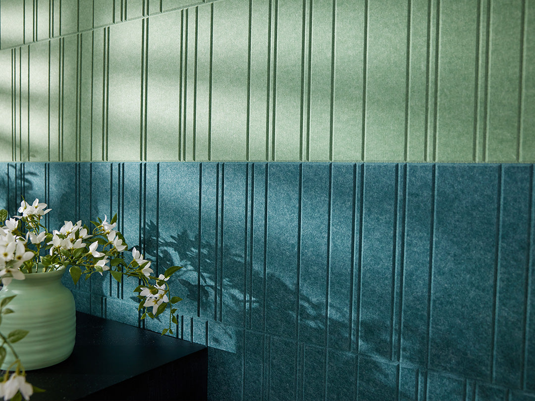 Green textured accent wall with kitchen table and chairs.