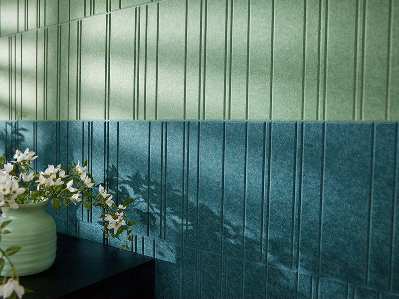 Green textured accent wall with kitchen table and chairs.