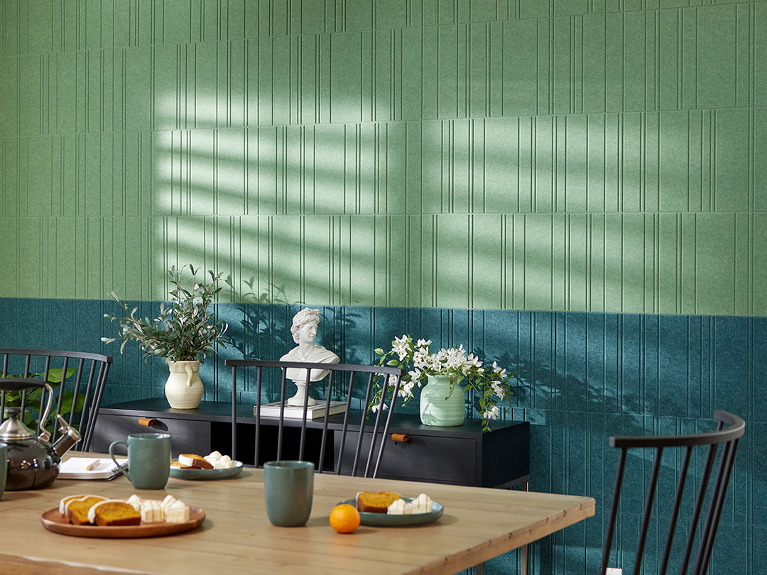 Green textured accent wall with kitchen table and chairs.