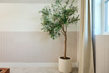 Beige parallel wainscoting panels installed on lower half of wall with white upper section and cream curtain.
