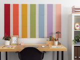 Bulletin board with seven vertical pastel pinstripes in red, orange, yellow, green, blue, purple, and pink.