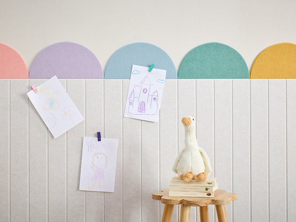 Pastel and Neutral colored acoustic wainscotting in a kid play room
