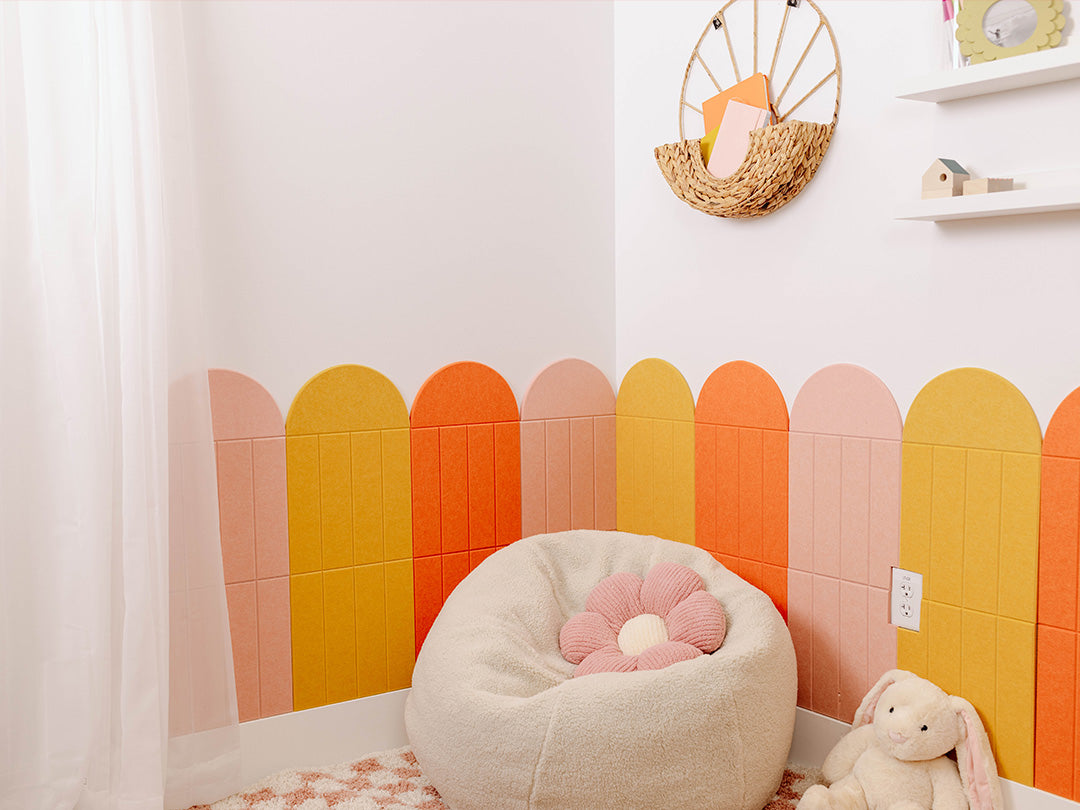 Children's room with colorful wall panels and a bean bag chair.