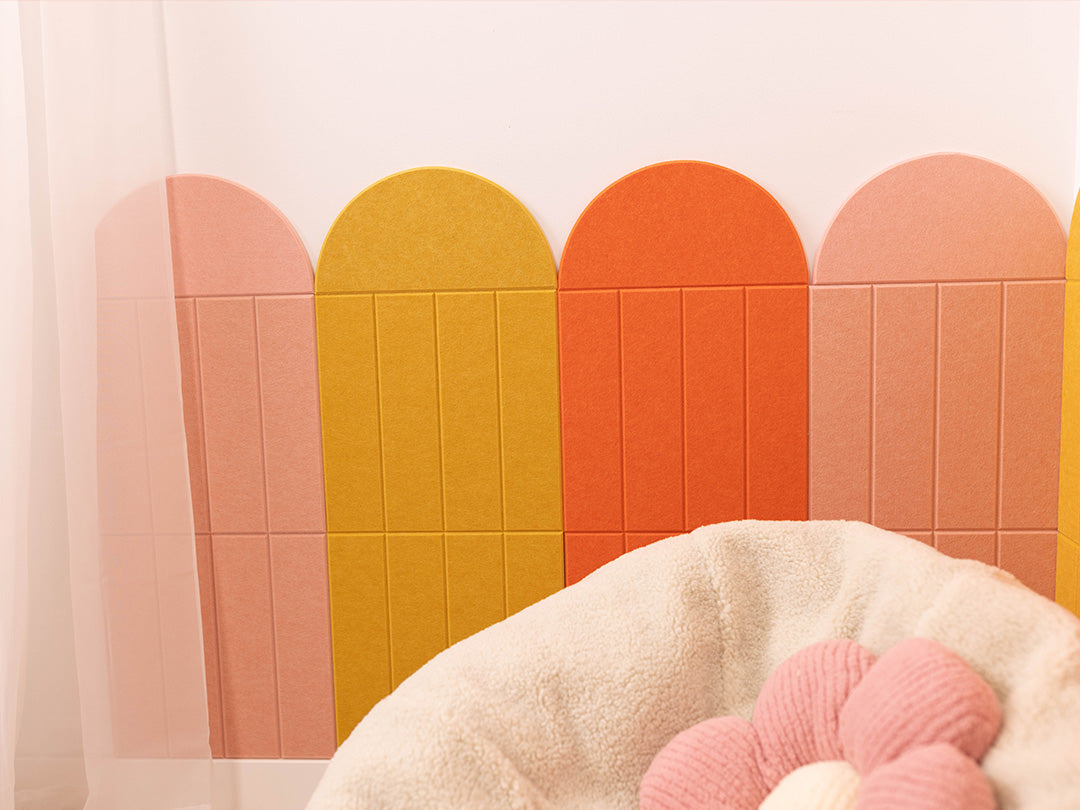 Colorful geometric wall design with a soft toy in the foreground