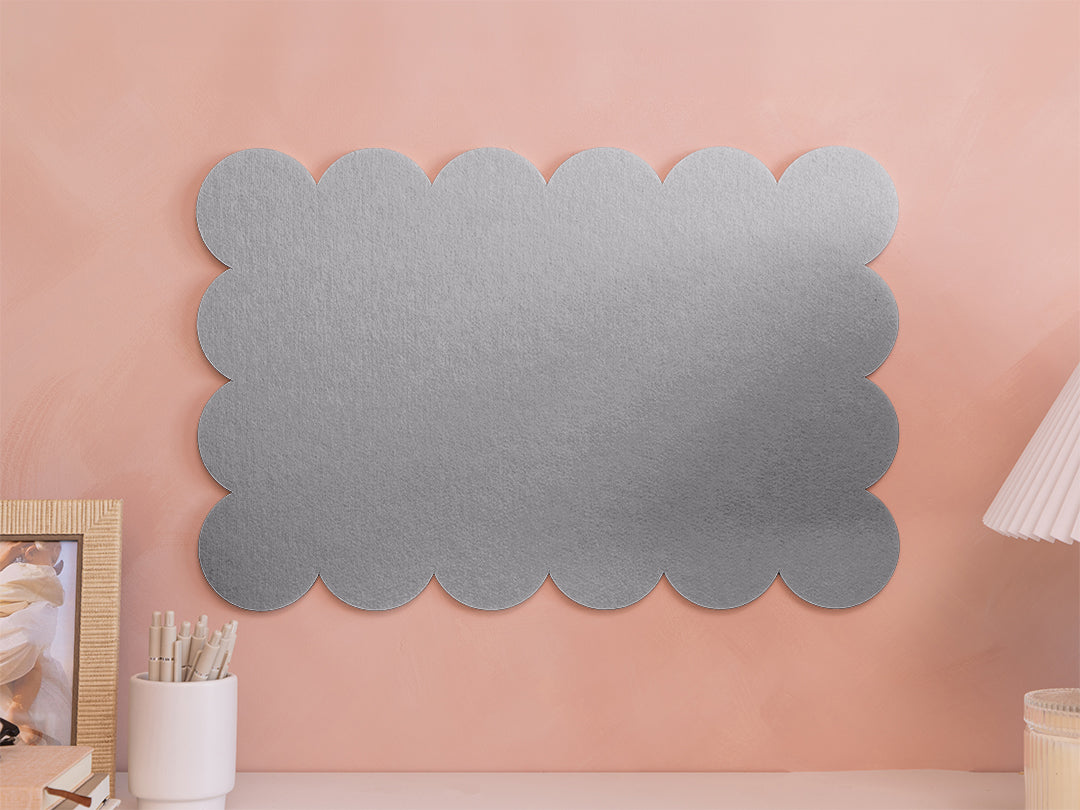 Gray scalloped wall art on a pink wall