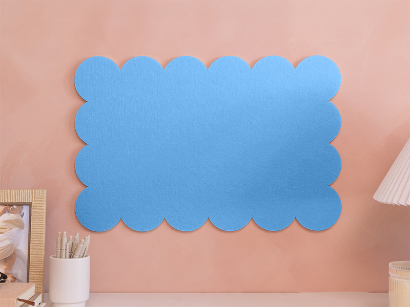 Blue scalloped decorative panel on a pink wall
