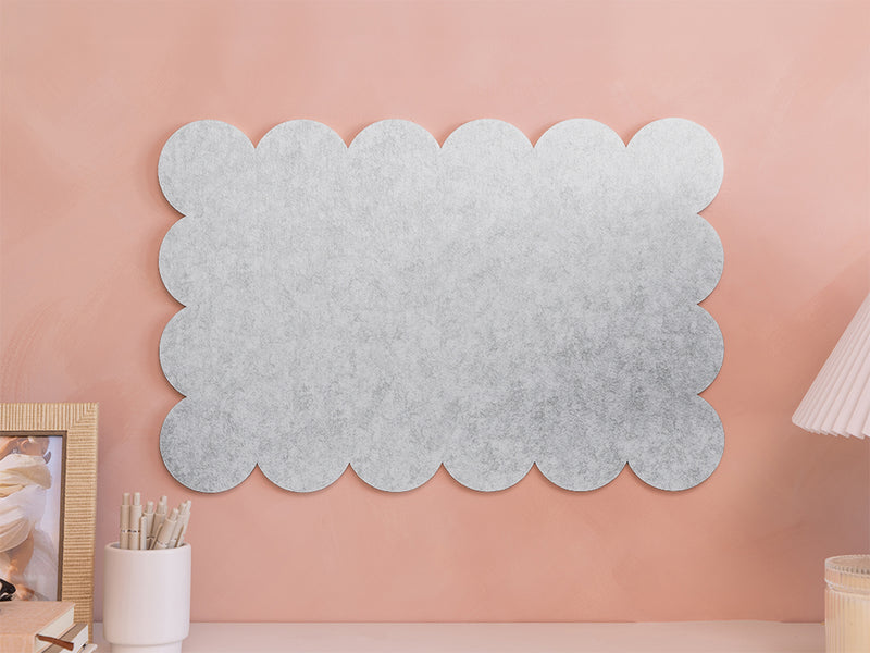 Decorative wall panel with scalloped edge on a pink wall