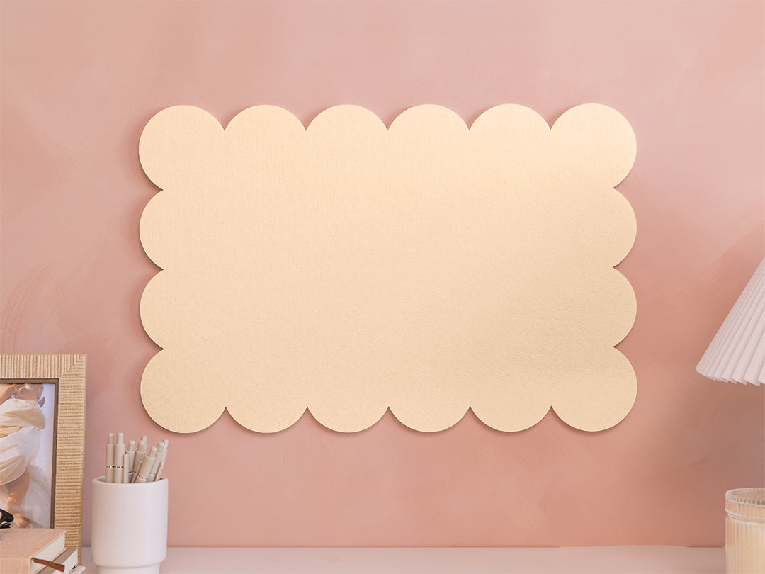 Decorative wall panel with scalloped edges on a pink wall