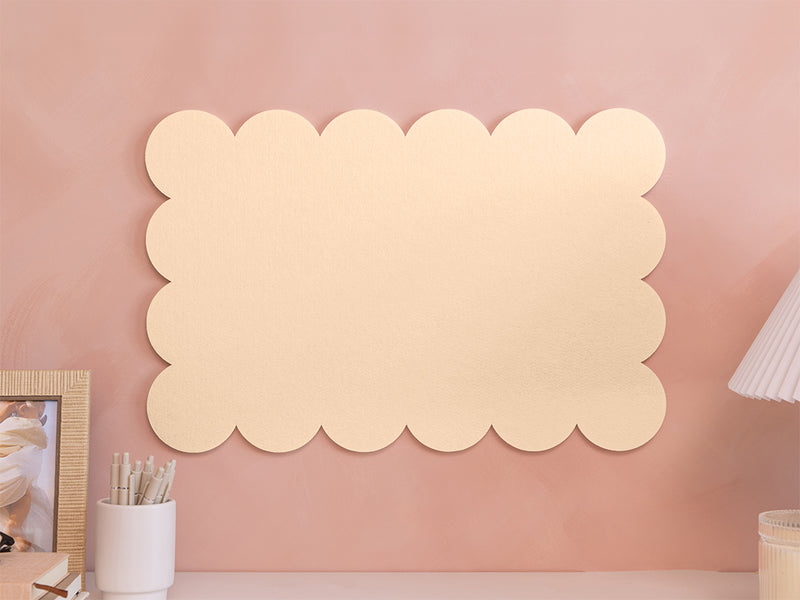 Decorative wall panel with scalloped edges on a pink wall