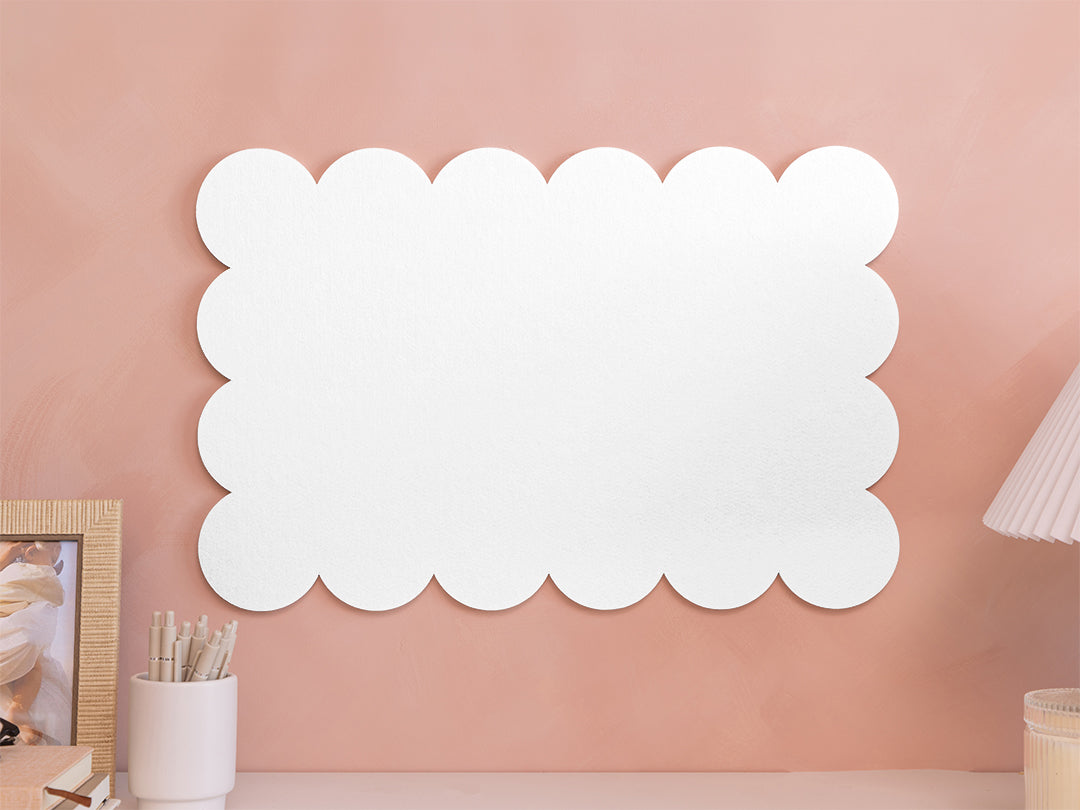 White scalloped mirror on a pink wall
