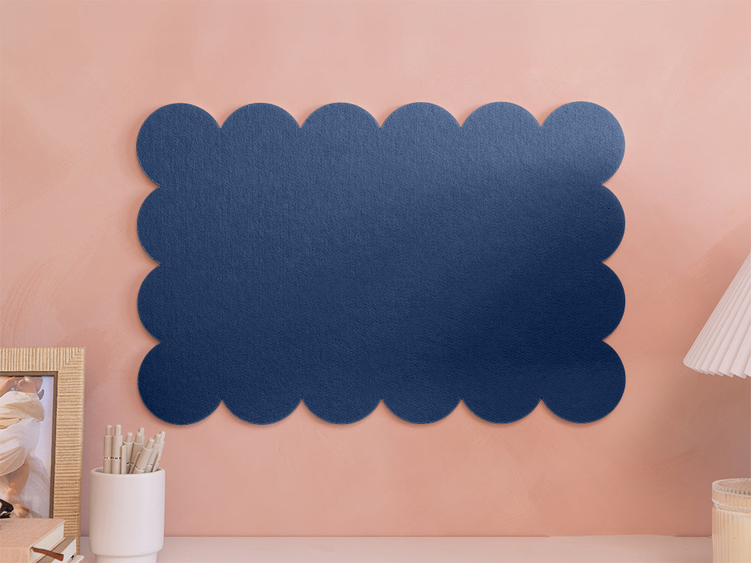 Navy blue scalloped decorative panel on a pink wall