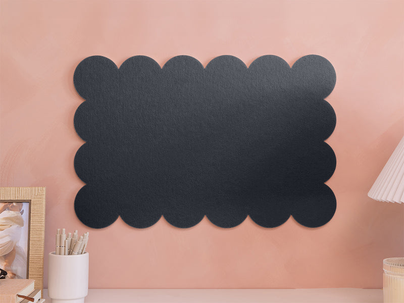 Black scalloped-edge acoustic panel on a pink wall