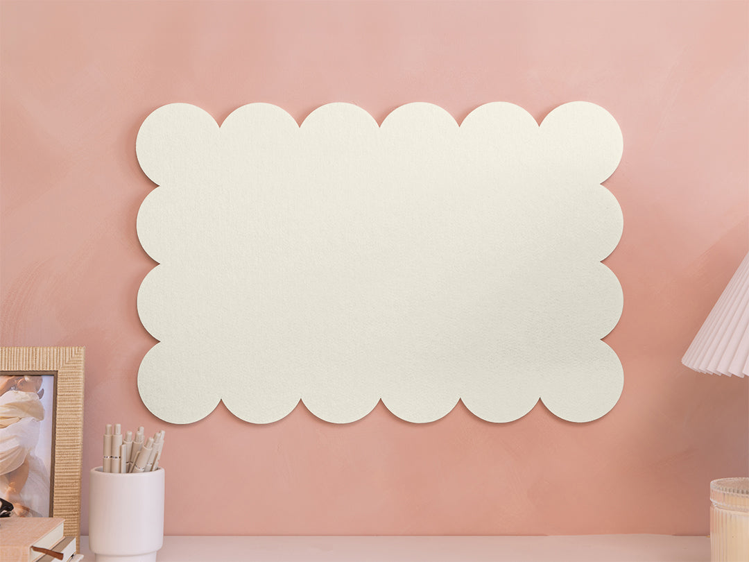 Decorative wall panel with scalloped edges on a pink wall