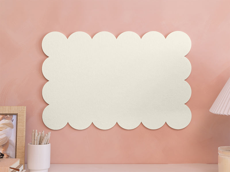 Decorative wall panel with scalloped edges on a pink wall