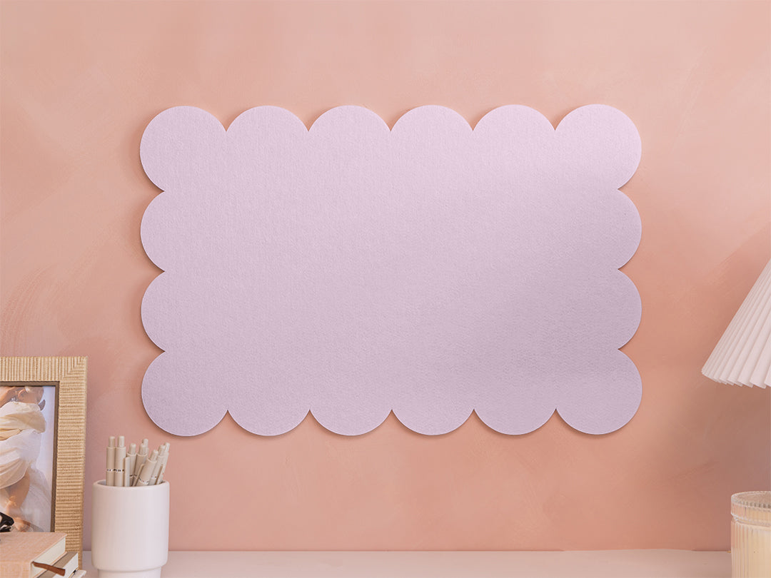 Decorative wall panel with scalloped edge on a pink wall