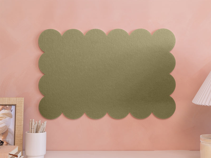 Green scalloped acoustic panel on a pink wall