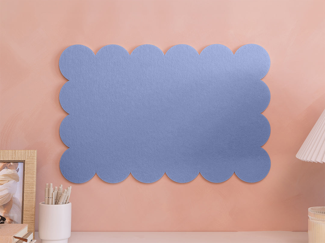 Blue scalloped acoustic panel on a pink wall