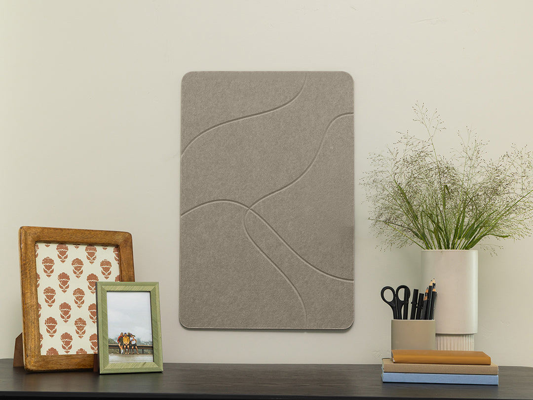 Gray acoustic panel on a wall with decorative items below